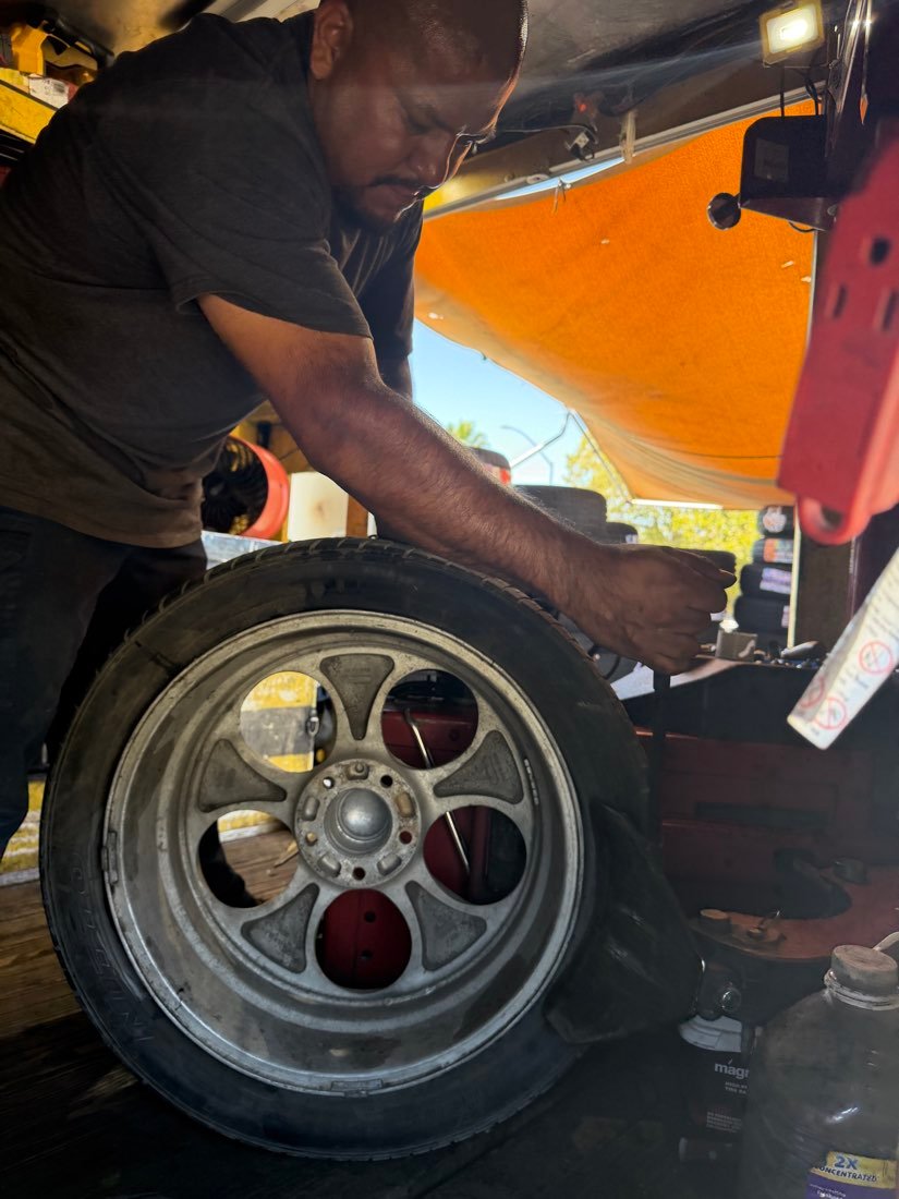 Close-up of a technician holding a wheel and tire