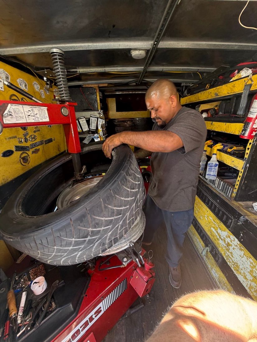 Technician performing tire service inside the mobile unit