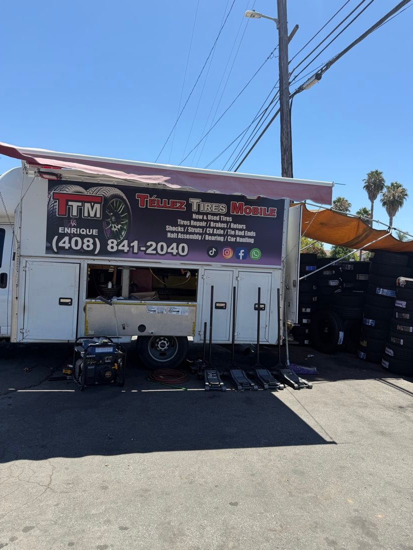 Close-up of the TTM — Téllez Tires Mobile trailer signage with contact information